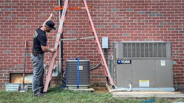 Newly installed air conditioning condenser beside a brick home in Greensboro NC